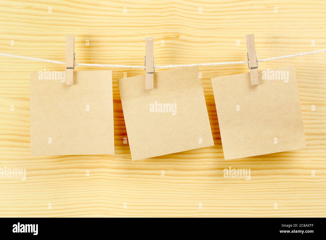 three blank notes on clothesline for messages Stock Photo - Alamy