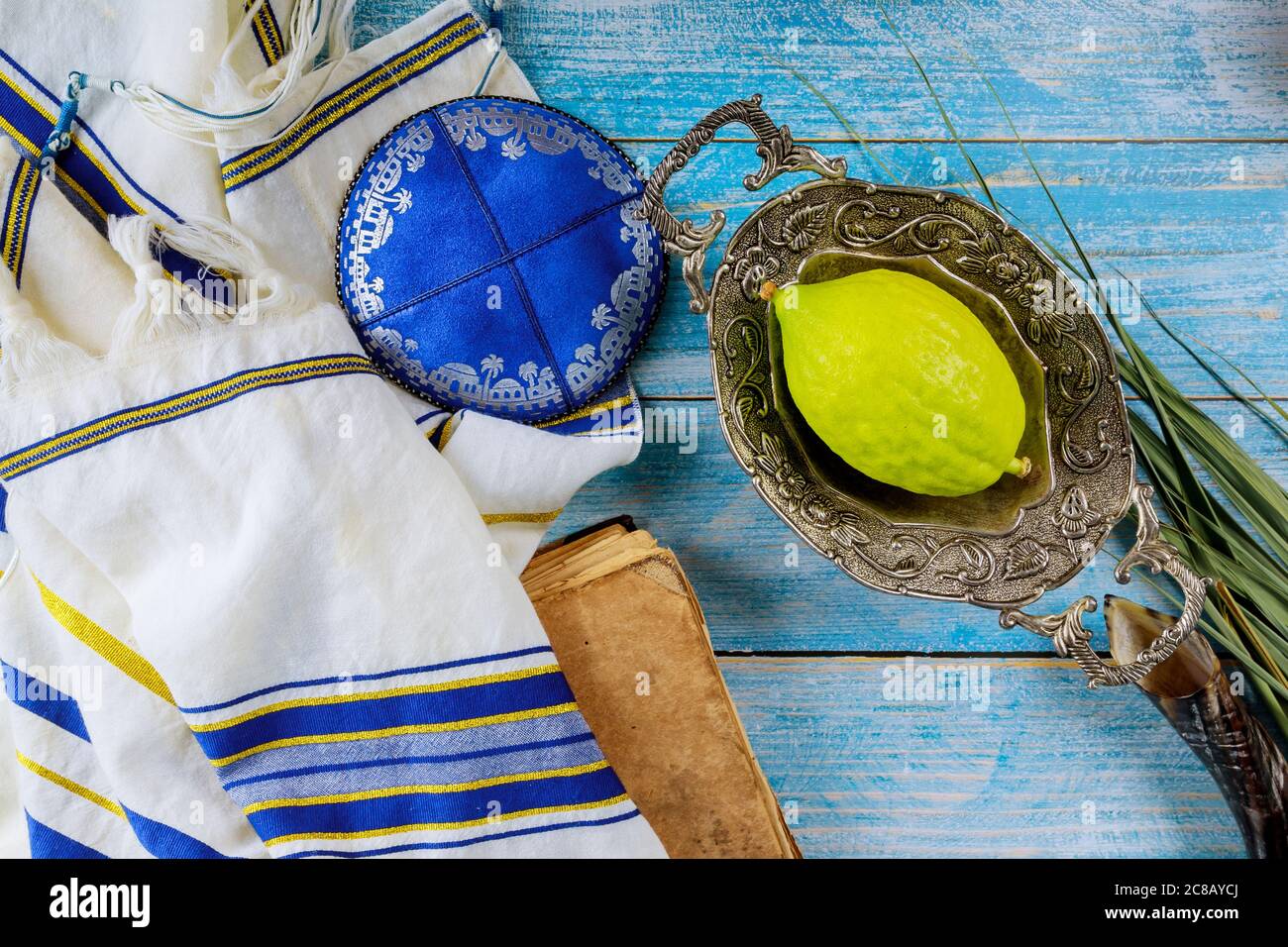 Traditional symbols Jewish festival of Sukkot Etrog, lulav, hadas, arava praying book kippah Tallit Jewish ritual Stock Photo