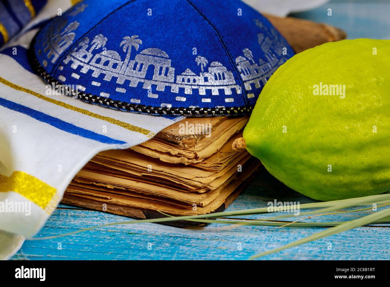 Jewish religious symbol festival of Sukkot traditional symbols Etrog, lulav, hadas, arava praying book kippah Tallit Stock Photo