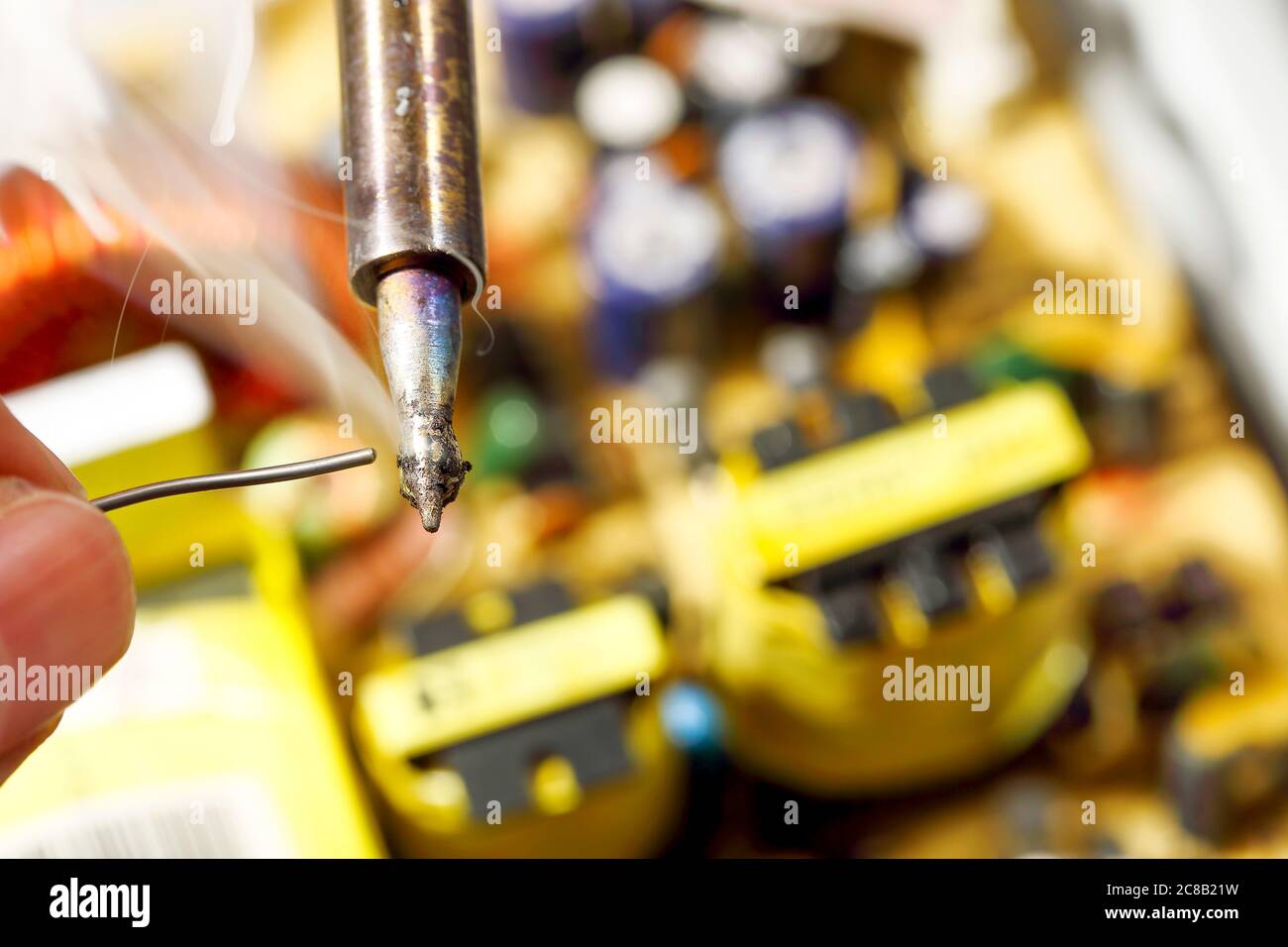 melting solder wire on soldering iron tip Stock Photo Alamy