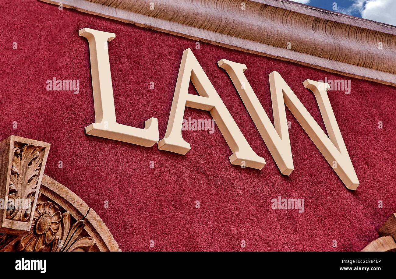 The word LAW on a Crimson Red Stucco Wall Stock Photo