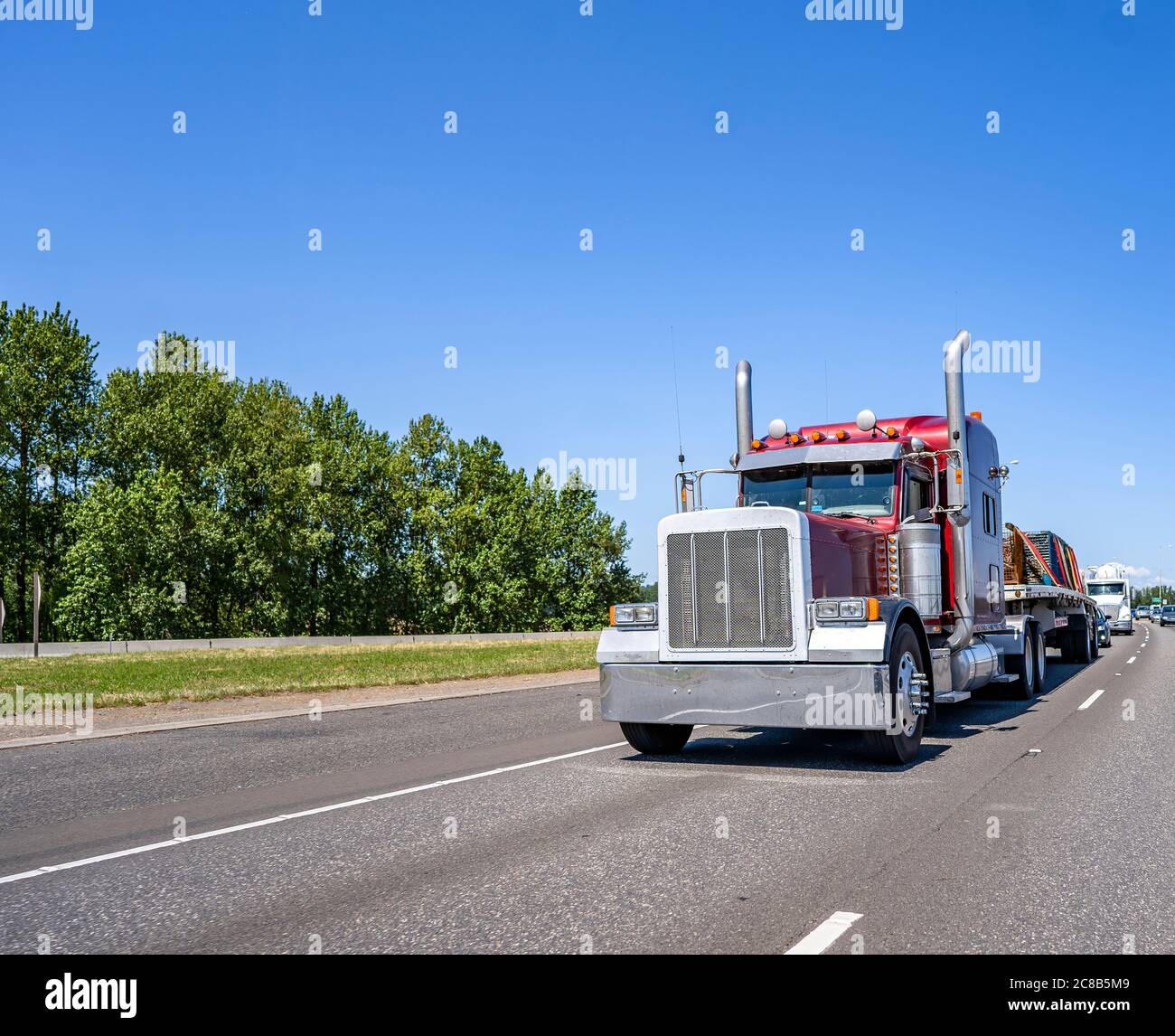 Big rig red industrial diesel long haul semi truck with flat bed semi ...