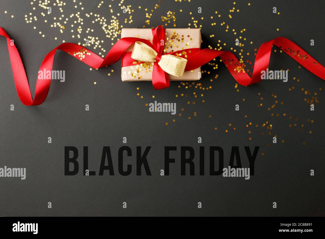 BLACK FRIDAY HOLIDAY SALE Craft gift box on a dark background, decorated with a bow, romantic luxury atmosphere. For seasonal shopping sales, consumer Stock Photo