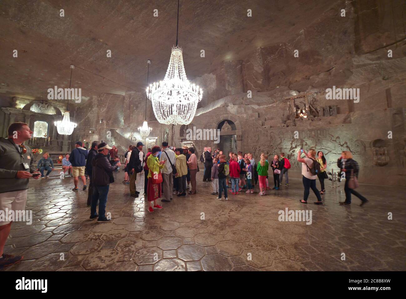 Wieliczka Salt Mine / Poland - June 10, 2019: large number of tourists visiting the interior of the famous salt mines decorated as a palace Stock Photo