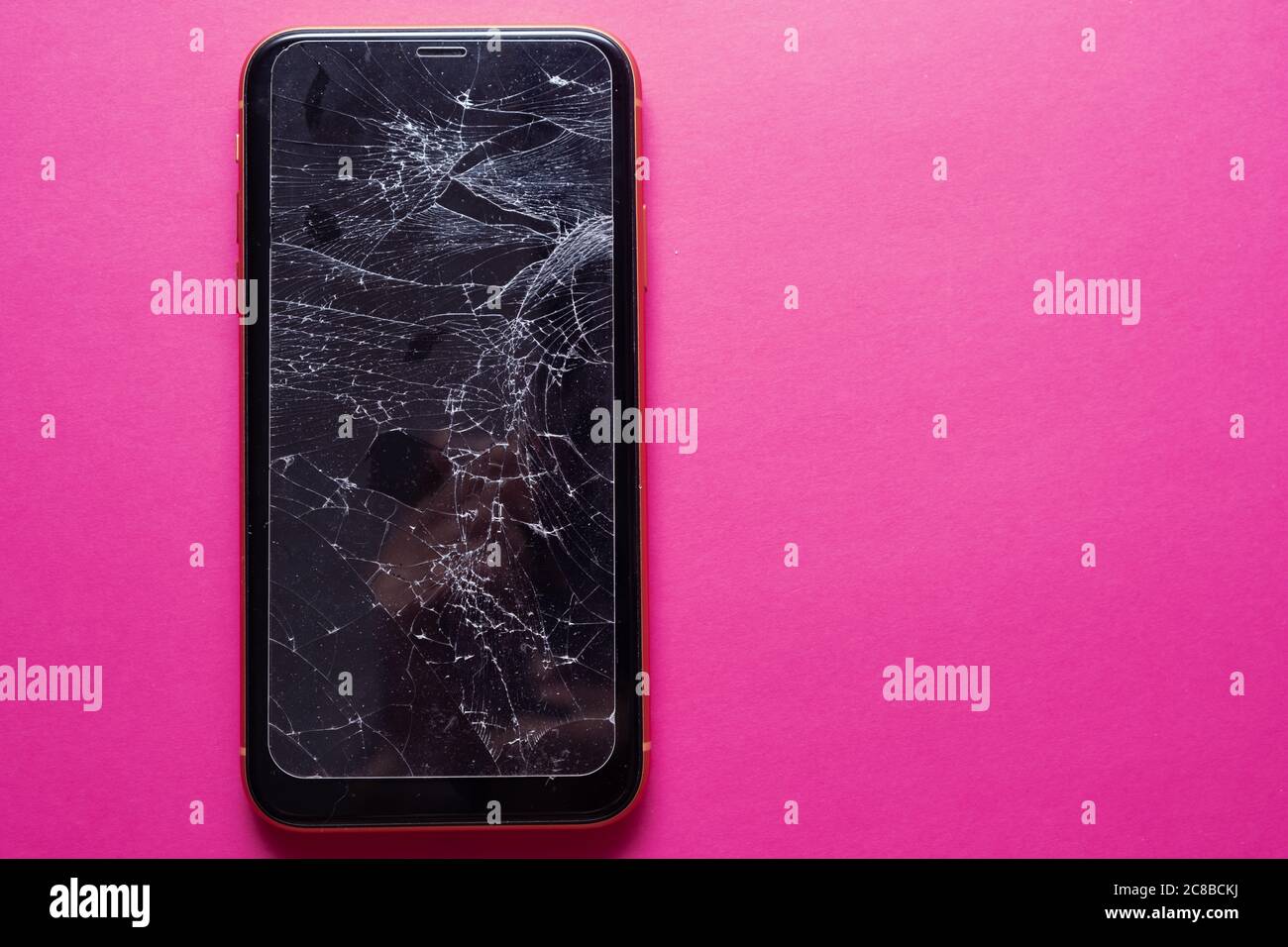 Broken glass mobile phone screen on a pink background Stock Photo - Alamy