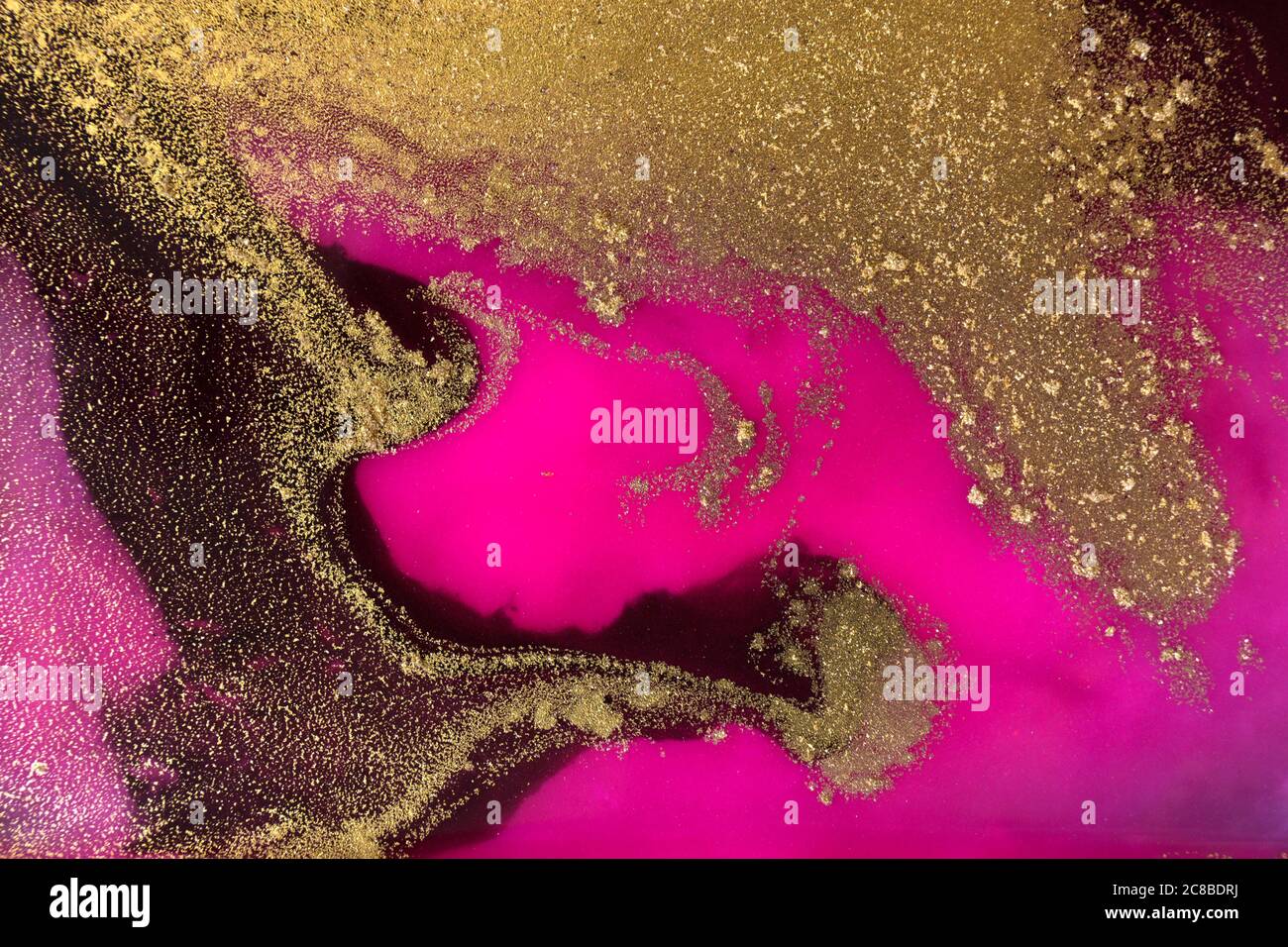Golden dust, black and pink background. Sparkling gold texture Stock