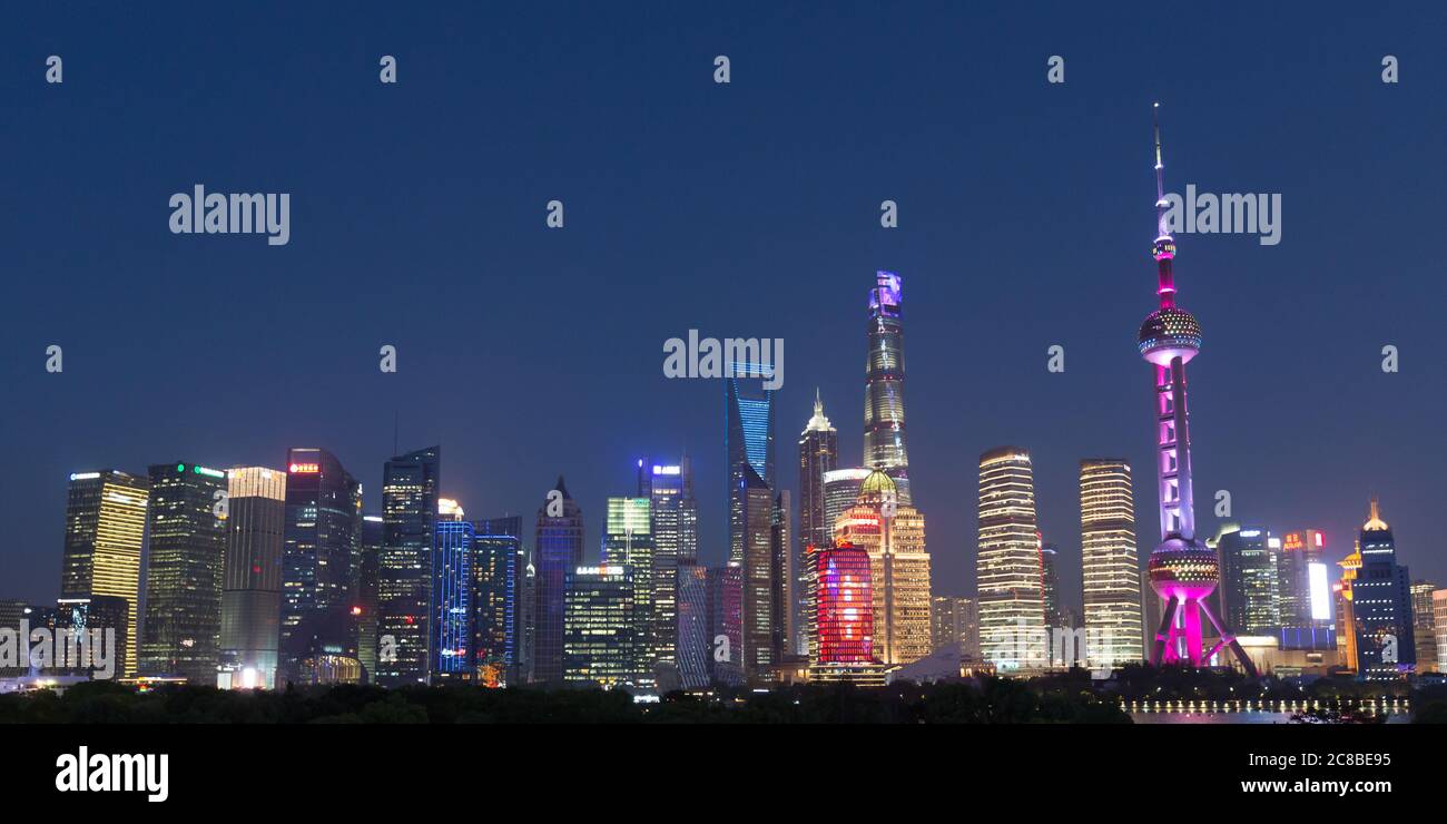Shanghai, China - April 19, 2018: Illuminated skyscrapers of Shanghai Pudong. Skyline of the chinese metropolis. Stock Photo