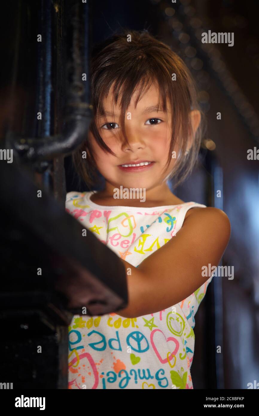 Young native girl posing on an old steam train at Heritage Park. Stock Photo