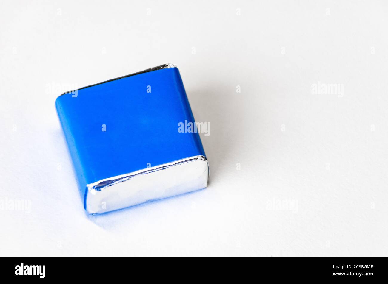 Blue cube on a white background, empty background on the right side for text Stock Photo