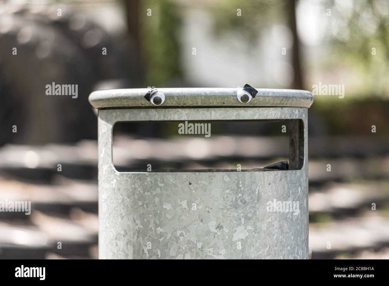 Googly eyes on a nervous trash can Stock Photo Alamy
