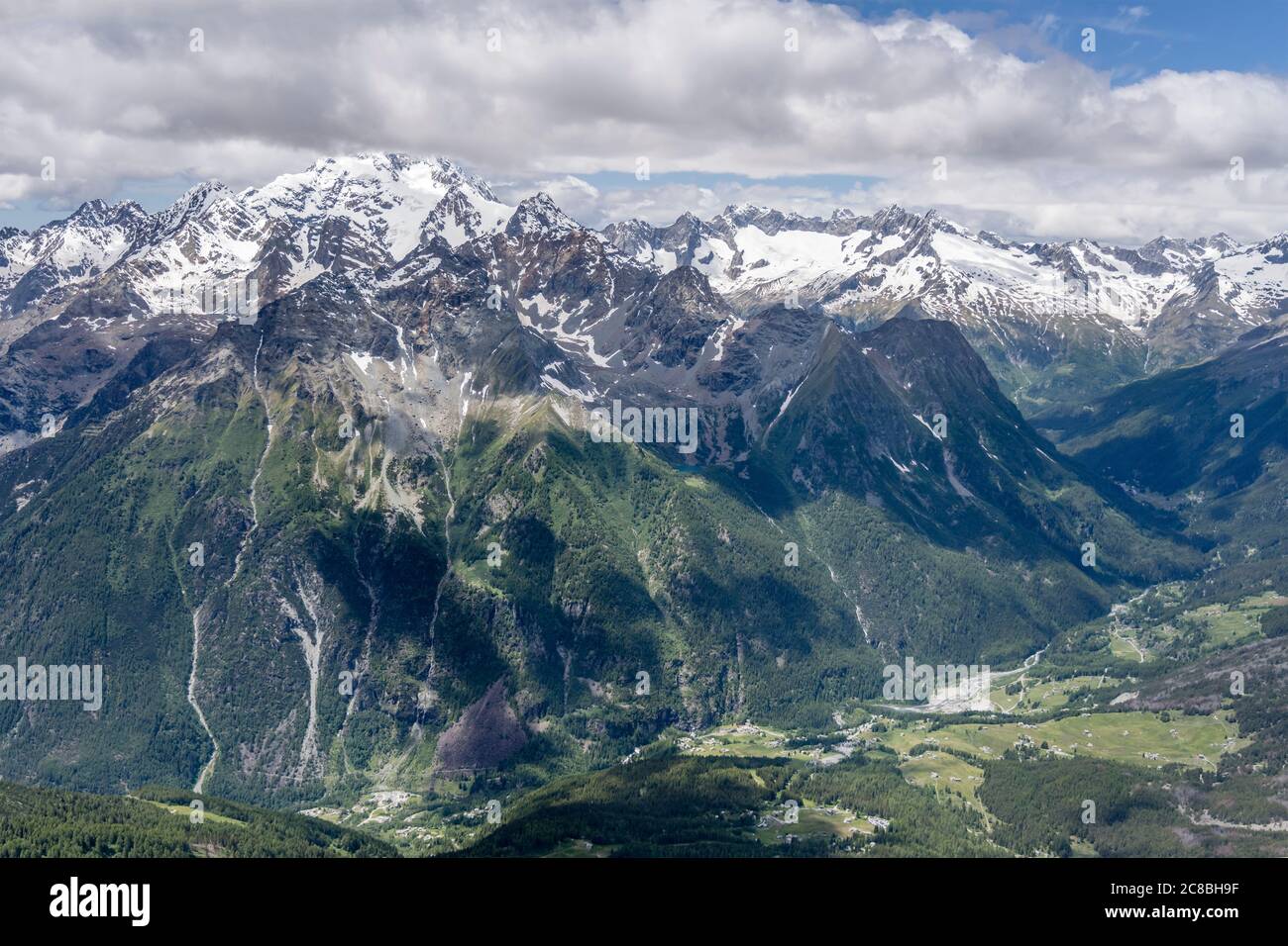 aerial shot, from a sailplane, of Mallero valley and east side of Disgrazia peak range, shot in Alps in bright late springtime light, Sondrio, Lombard Stock Photo