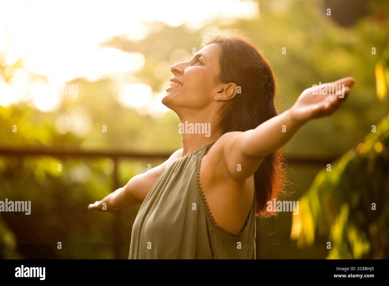 Beautiful woman relaxing and feeling nature at park Stock Photo