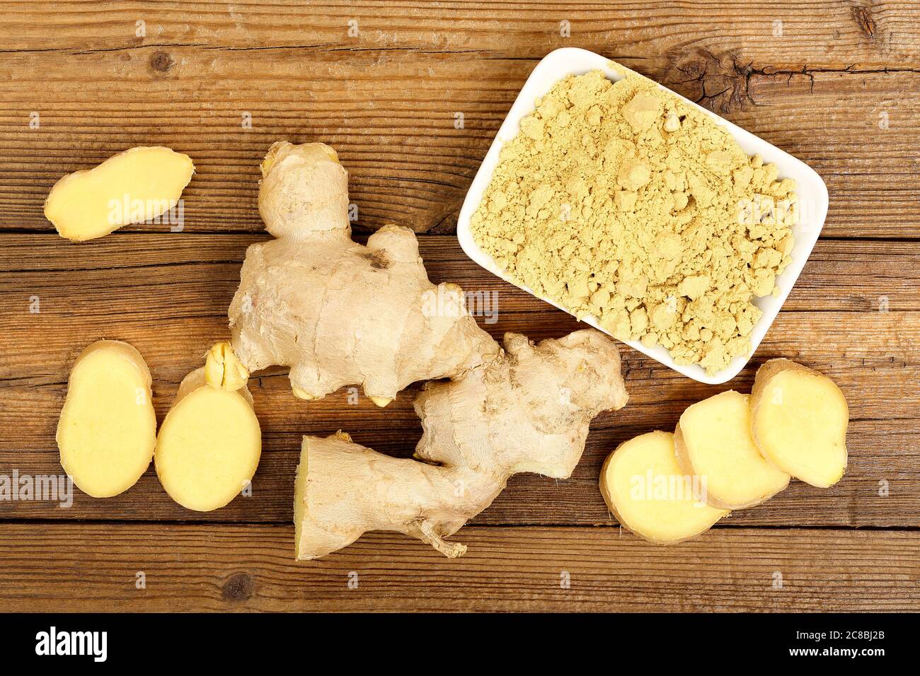 ginger root and powder on old wooden table Stock Photo