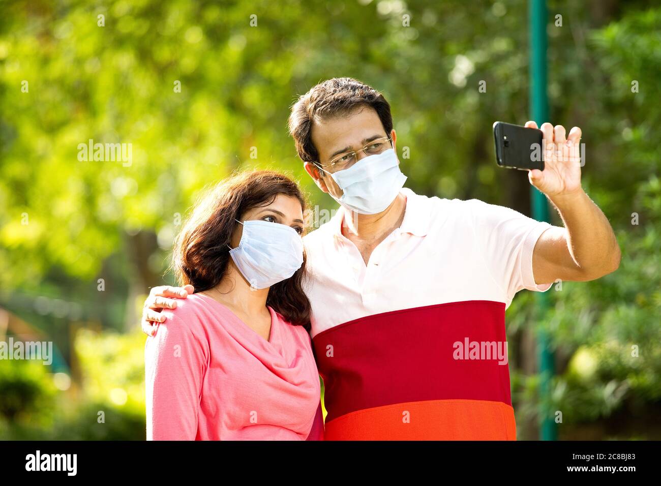 Premium Photo  Cute little indian girl wearing health mask, facing camera,  isolated over orange background