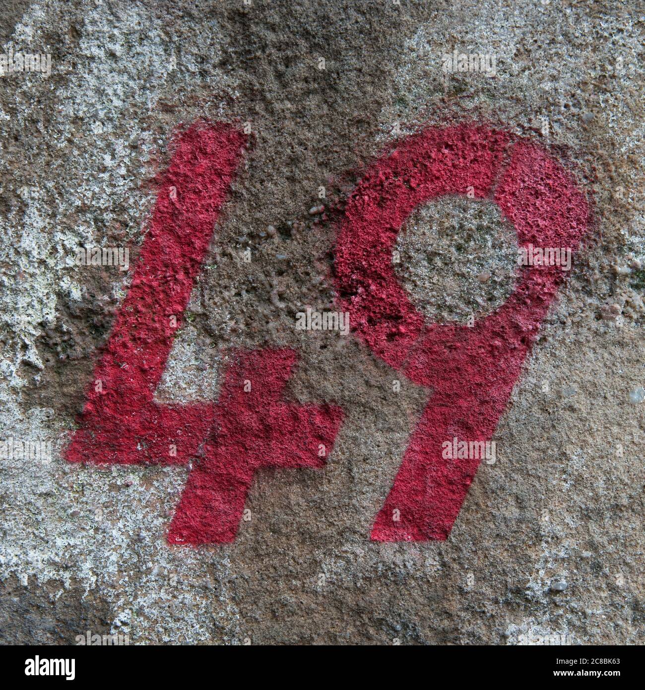 A Close Up Of The Number 49 Stencilled In Red Paint On A Wall Stock Photo