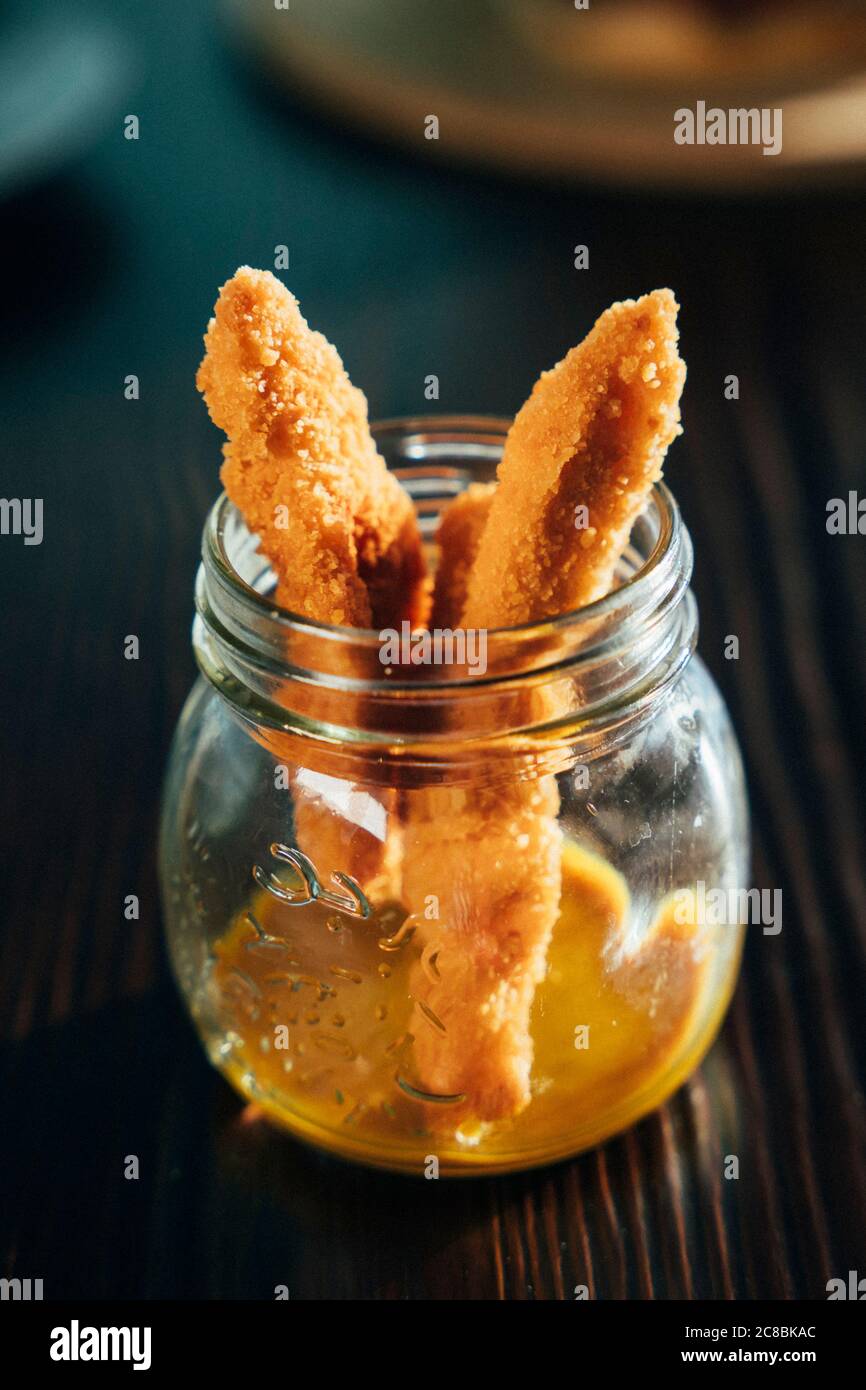 Chicken finger with mustard sauce in a glass bowl Stock Photo Alamy