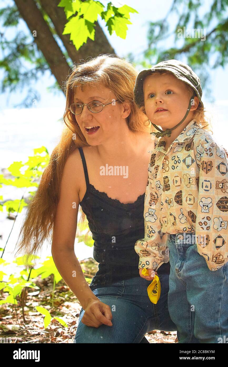Mother and son out enjoying the forest during their hike Stock Photo ...