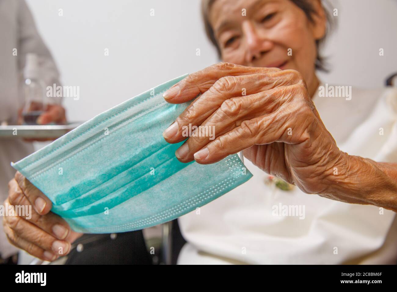 Elderly woman wearing a mask hi-res stock photography and images - Alamy
