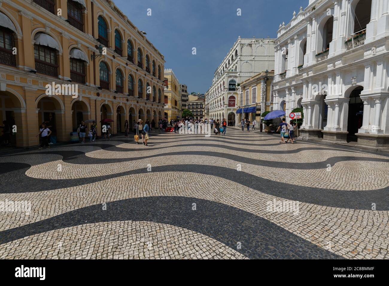 Macao, China - May 27, 2017: View on Senado Square. Famous for its wavy, striped pavement. To the left & right neo classical buildings. Part of the Un Stock Photo