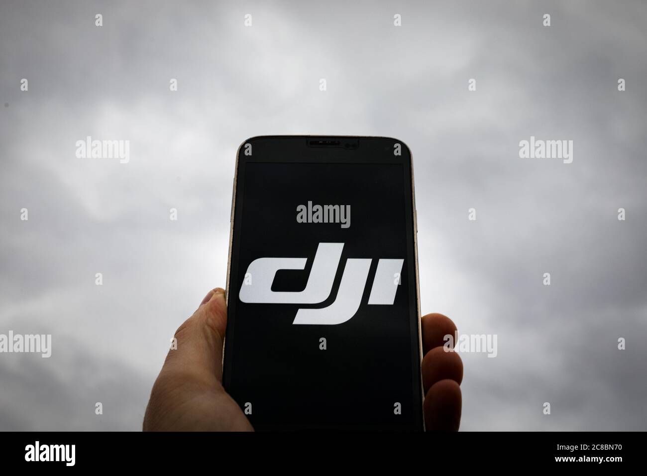 In this photo illustration a DJI logo seen displayed on a smartphone. Stock Photo