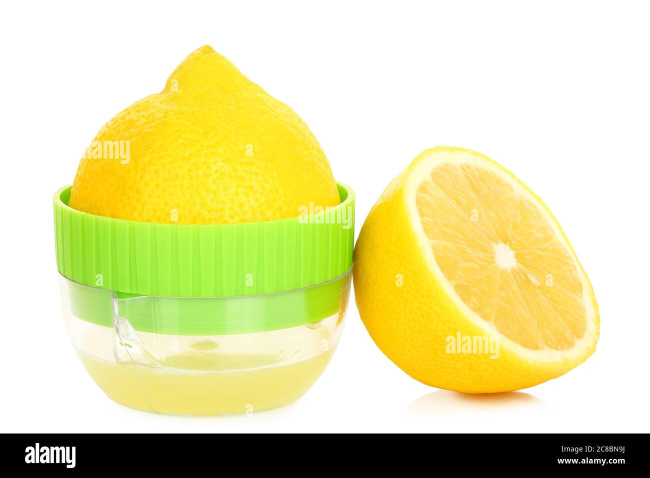 lemon on small juicer and half a lemon isolated on white Stock Photo
