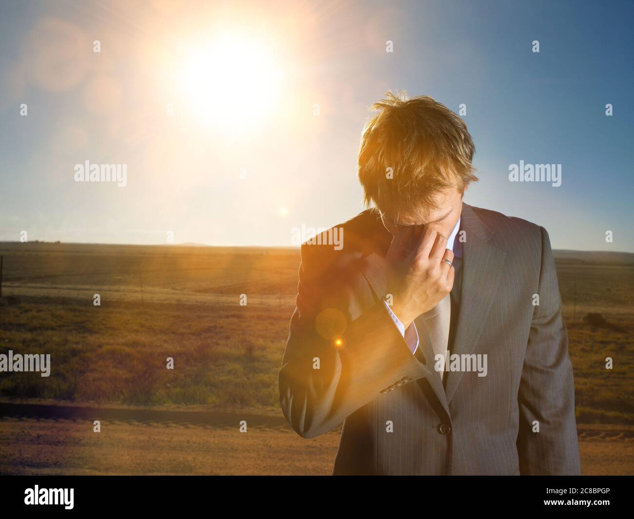 Businessman in suit lost in the desert Stock Photo