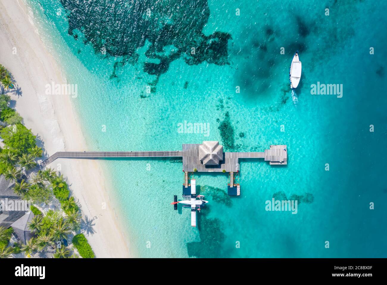 Perfect aerial landscape, luxury tropical resort or hotel with water villas and beautiful beach scenery. Amazing bird eyes view in Maldives, landscape Stock Photo