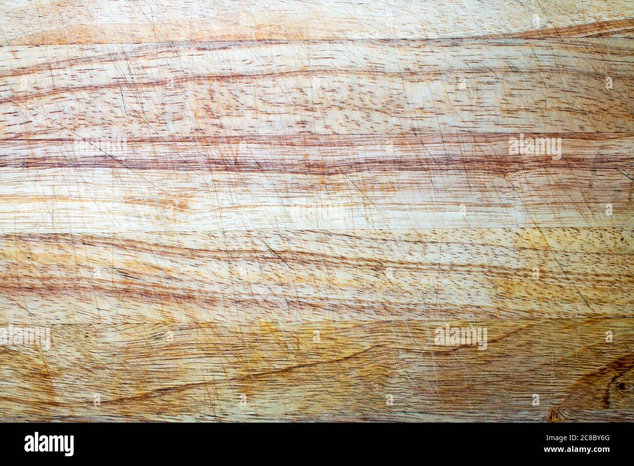 Wooden chopping board texture covered in score marks from knife usage