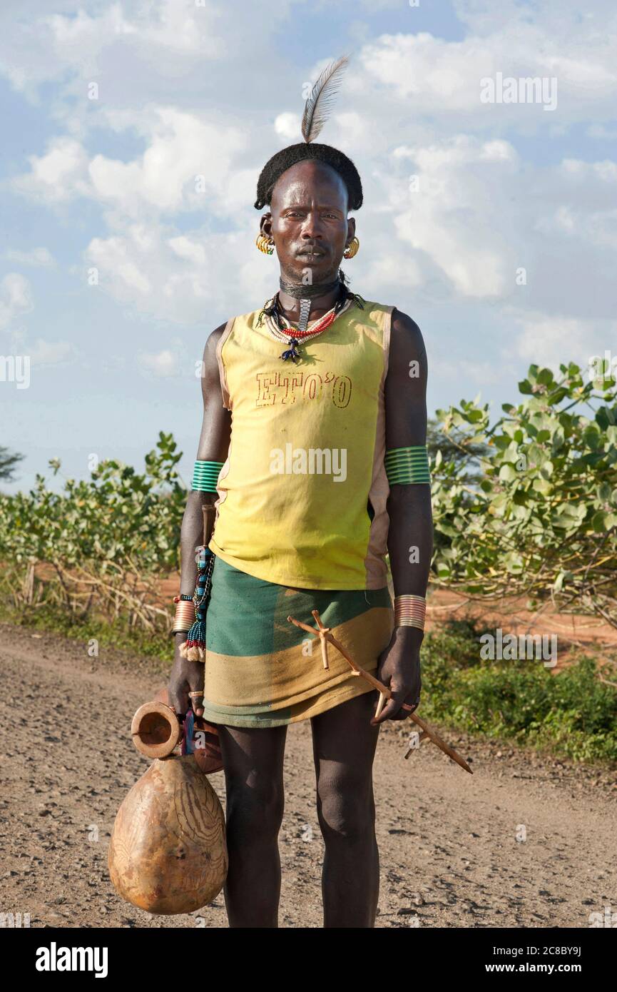 OMO VALLEY - ETHIOPIA - DECEMBER 1st, 2013   Unidentified young warrior in the desert of Omo Valley, Ethiopia Stock Photo