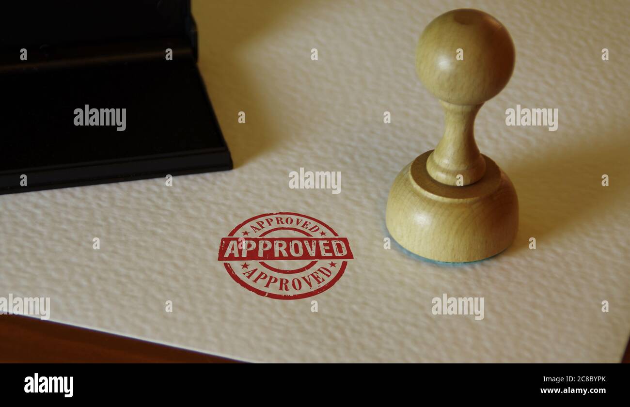 Approved stamp and stamping hand. Found, accepted, admitted and success concept. Stock Photo