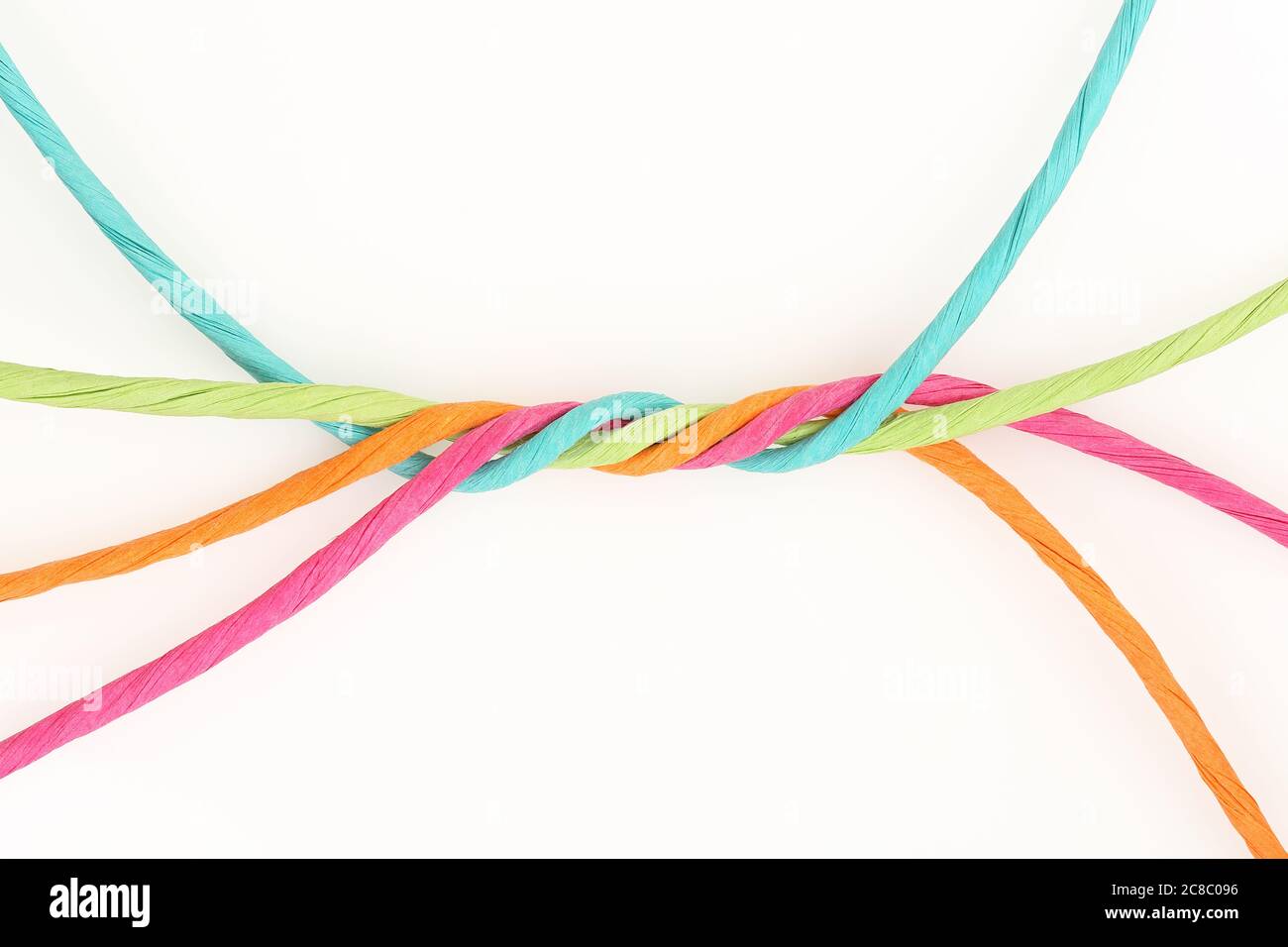intertwined colorful cords on white, abstract unity concept Stock Photo