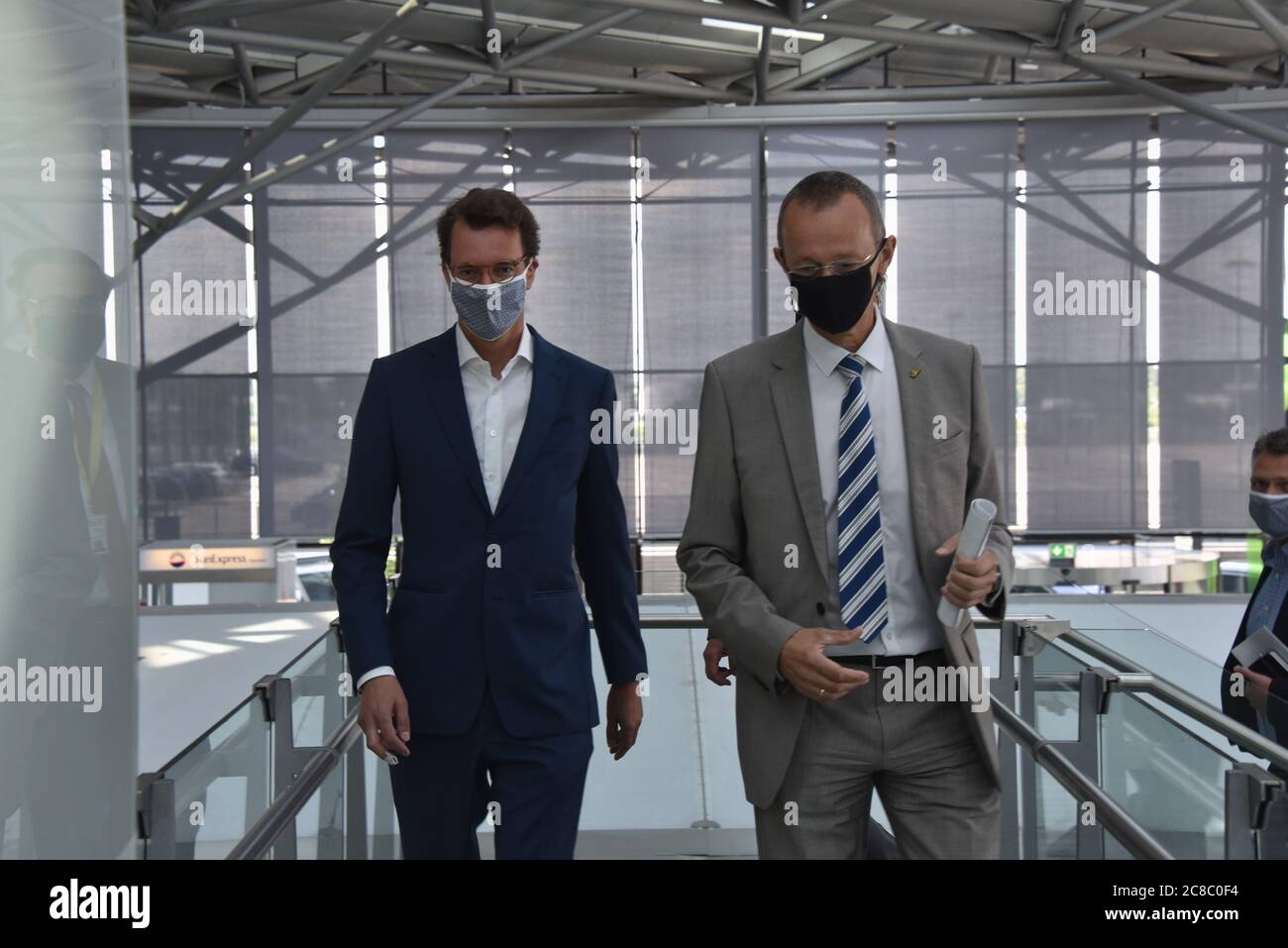 Cologne, Germany. 22nd July, 2020. Hendrik Wüst (l-r), Minister of Transport of the State of North Rhine-Westphalia, and Johan Vanneste, Managing Director of Flughafen Köln/Bonn GmbH, come with mask to the presentation of the feasibility study on the subject of flight taxis at Cologne Bonn Airport - Perspective of a new technology. Credit: Horst Galuschka/dpa/Alamy Live News Stock Photo