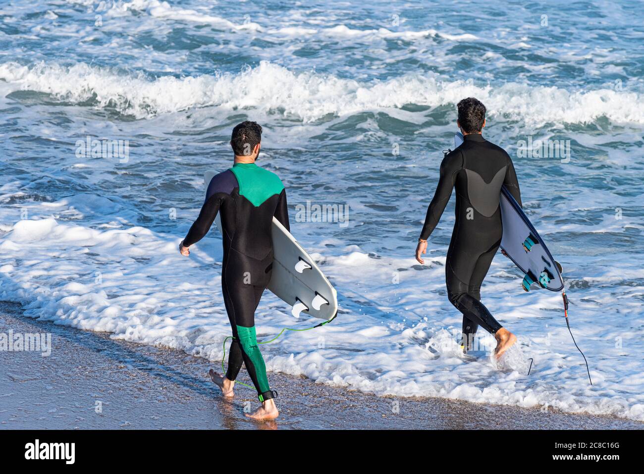 Two sporty surfing friends with big longboard surf surfboard board