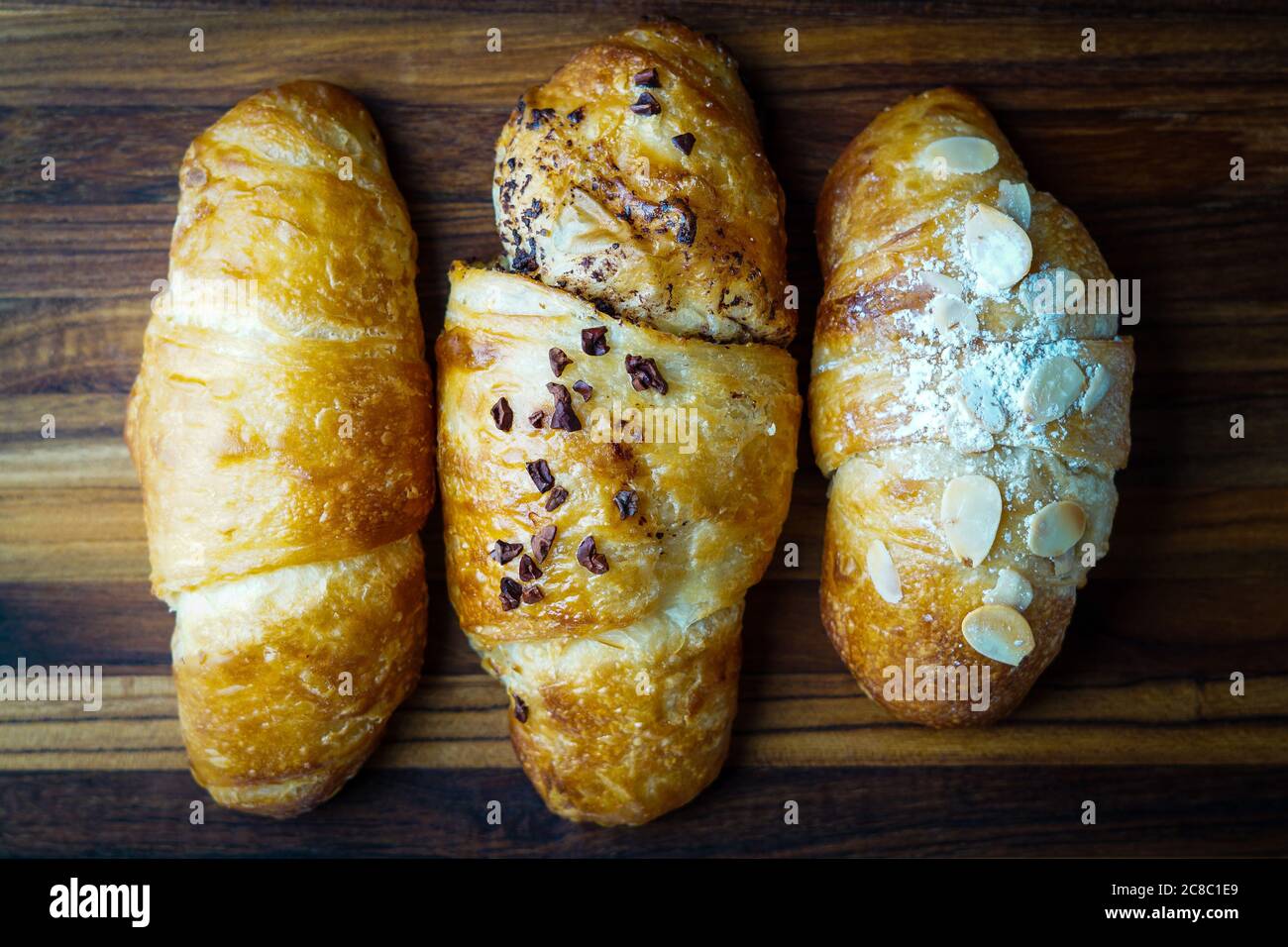 Three croissants on a plate Stock Photo