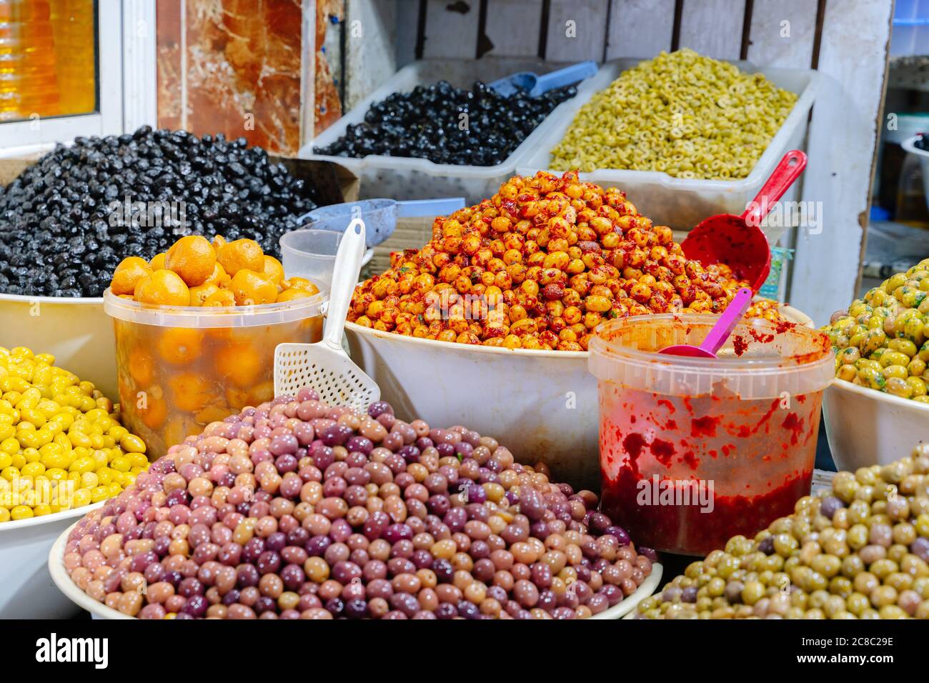 Olive shop with different types of olives in containers in a market in