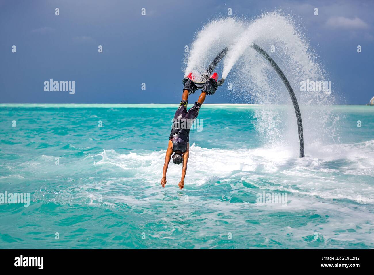 Professional pro fly board rider in tropical sea, water sports concept background. Summer vacation fun outdoor sport Stock Photo