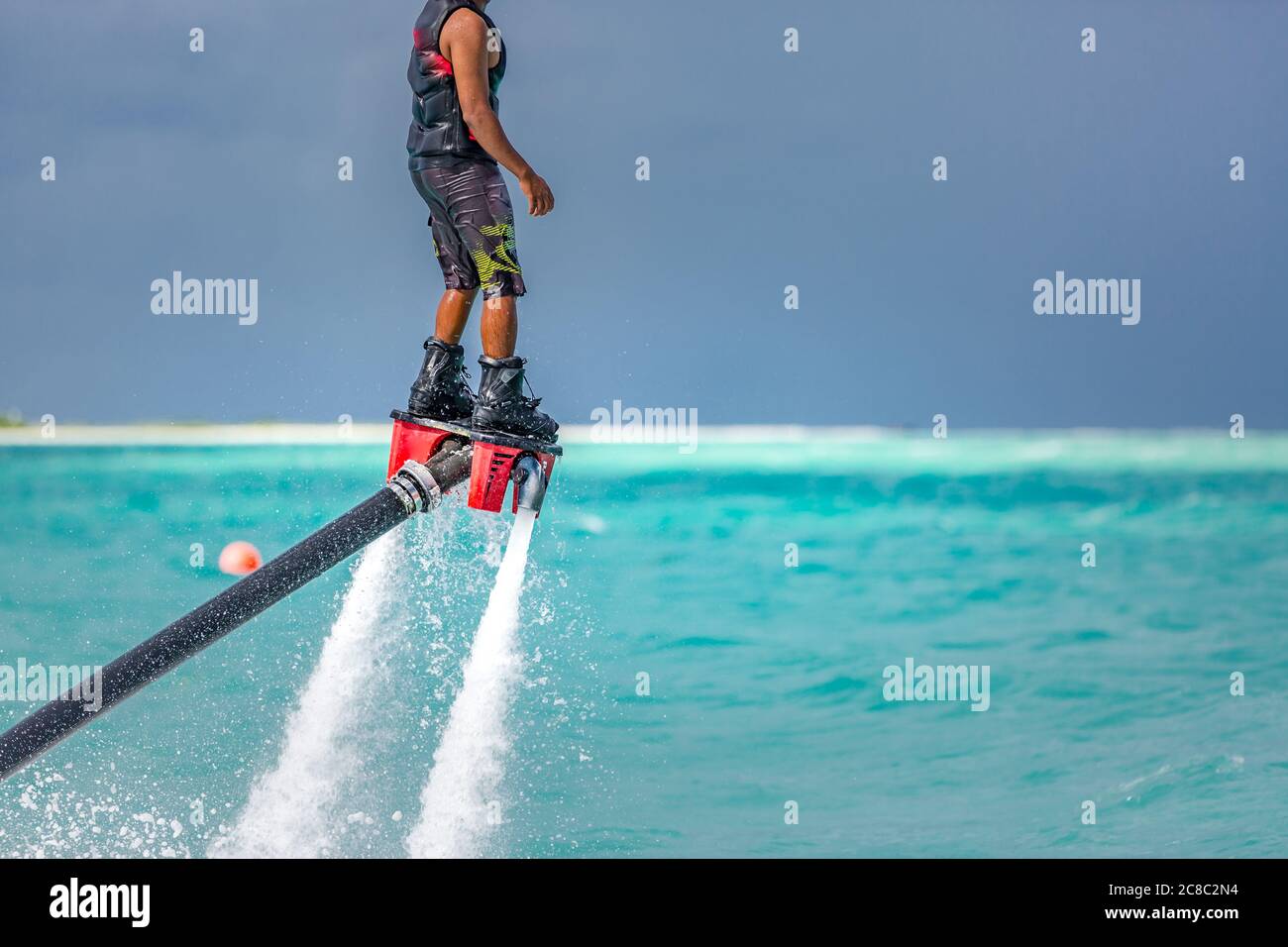 Flying Reeds Sports Professional pro fly board rider in tropical sea, water sports concept ...