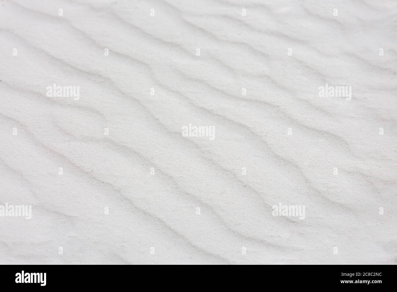Wavy texture of white sands blown in the wind. Background of white sand nature texture Stock