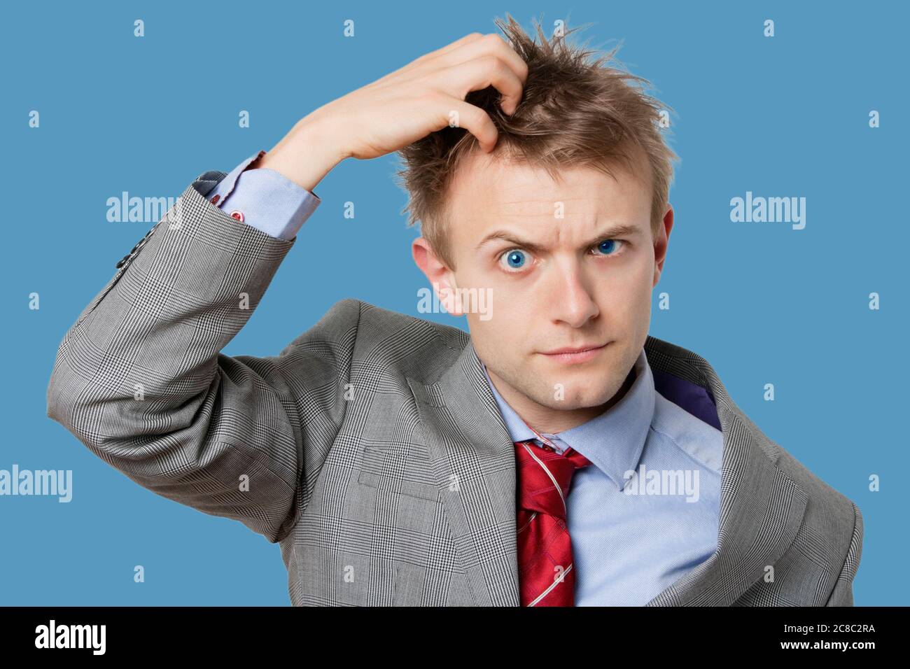 Portrait of confused businessman scratching head Stock Photo Alamy