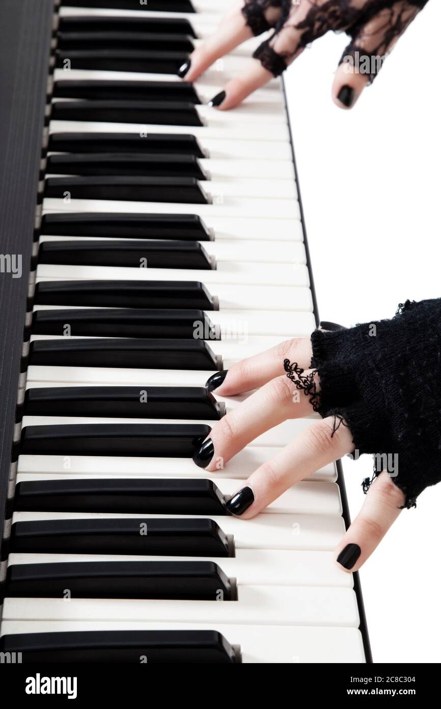 Female goth band playing keyboard piano Stock Photo