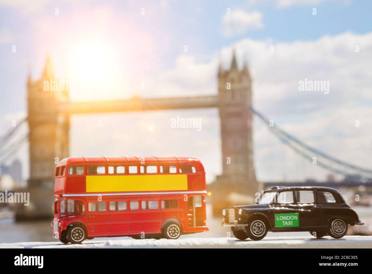 Close-up view of public transport figurines with Tower Bridge in the background Stock Photo