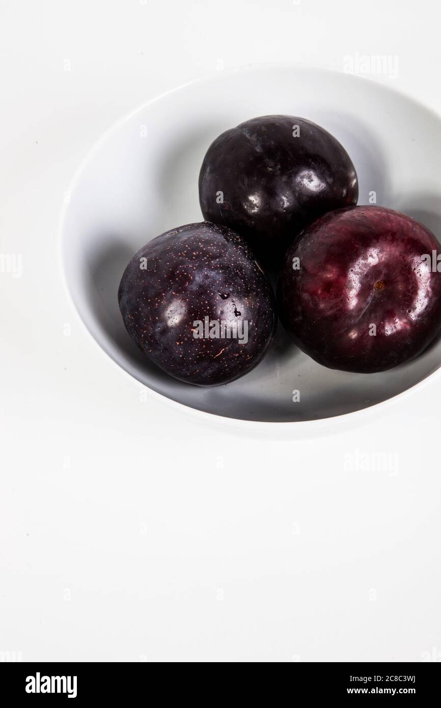 Plums in bowl Stock Photo