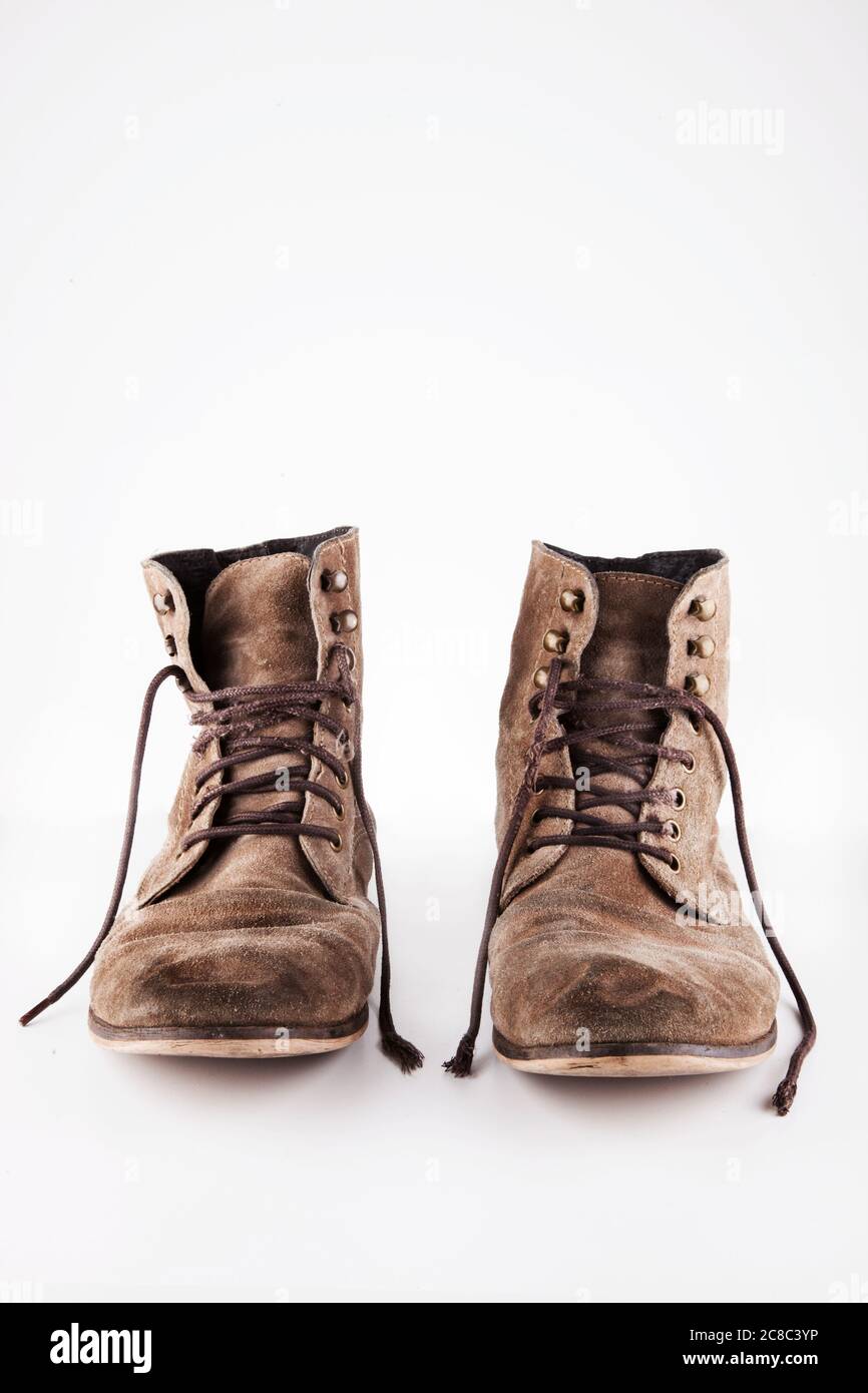 equilibrium Honesty Career Brown worn vintage boots with untied laces in studio Stock Photo - Alamy