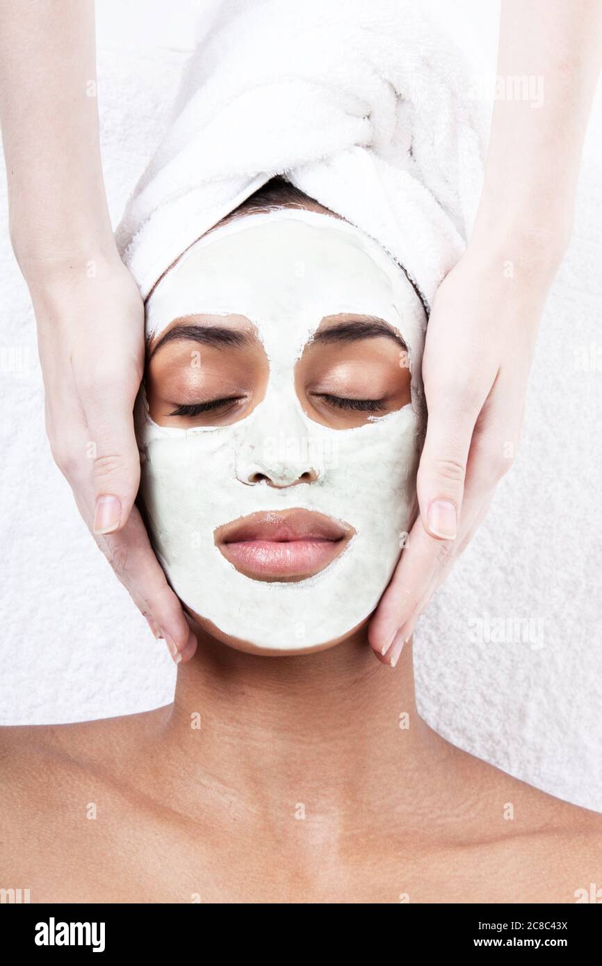 Female having face rub mask in spa Stock Photo