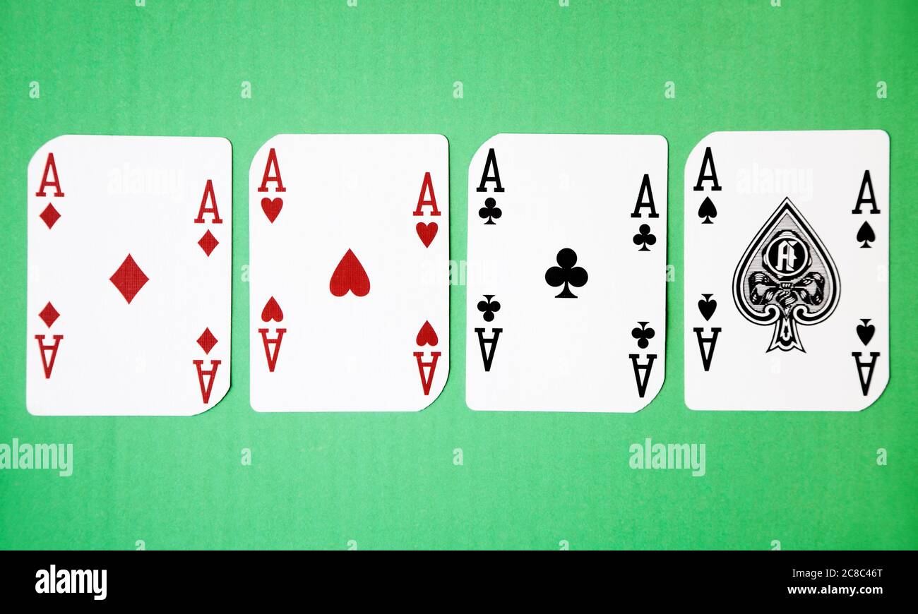 Four Aces against green background Stock Photo