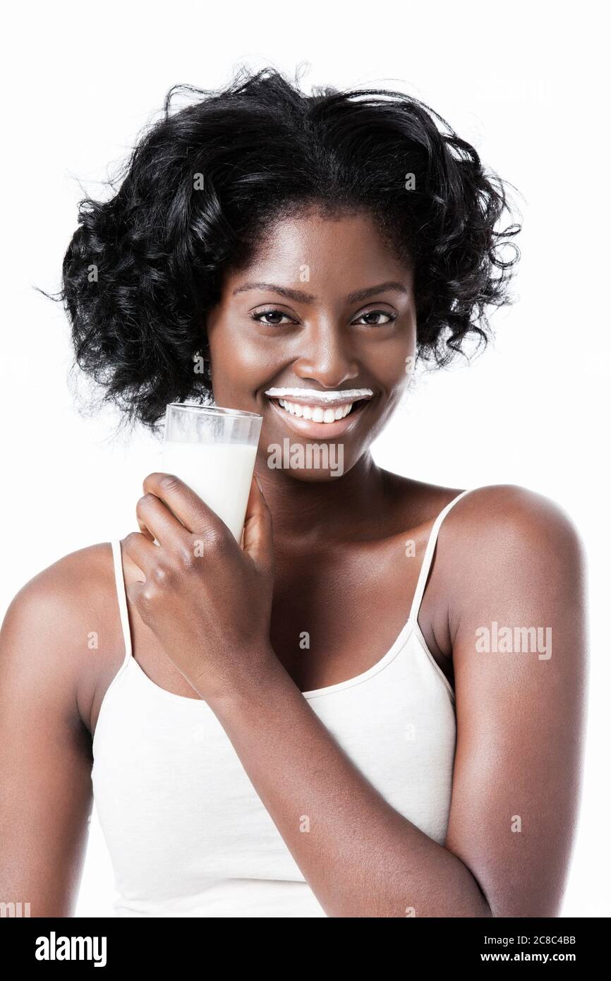 Attractive black woman drinking milk with milk moustache Stock Photo