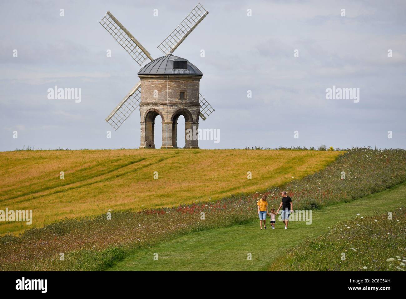 Visitors walk by Chesterton Windmill in Chesterton, Warwickshire. Stock Photo