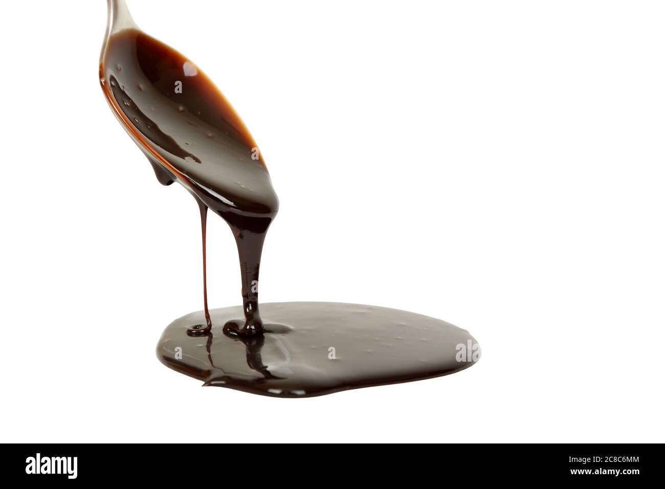 chocolate syrup dripping from spoon Stock Photo Alamy