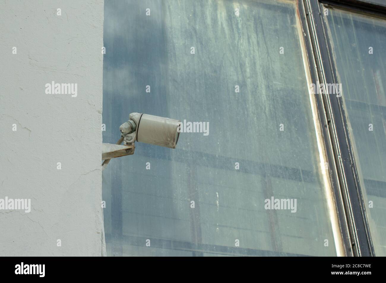 CCTV security camera on building wall outdoor. Urban street view Stock Photo