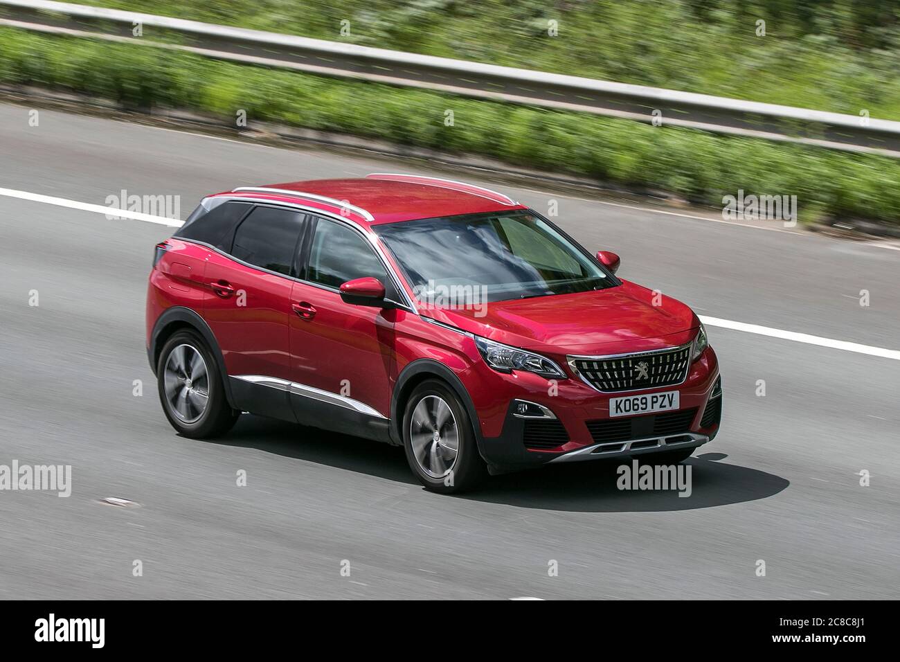 A 2020 Peugeot 3008 Allure Bluehdi Red Car SUV Diesel driving on the M6motorway near Preston in Lancashire, UK Stock Photo